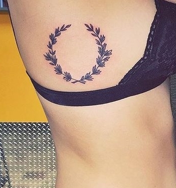 Изображение лаврового венка на ребрах девушки